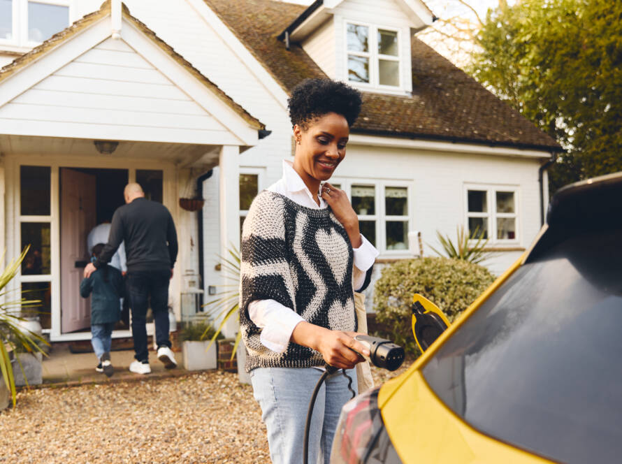 woman using EV charger
