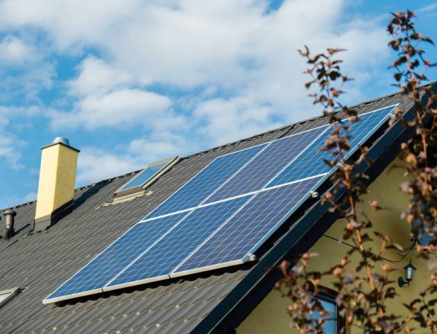 New ecologic house with solar panels Alternative to conventional energy. The battery is charged from a solar cell Advertisement Green energy Sustainable life Renewable alternative energy